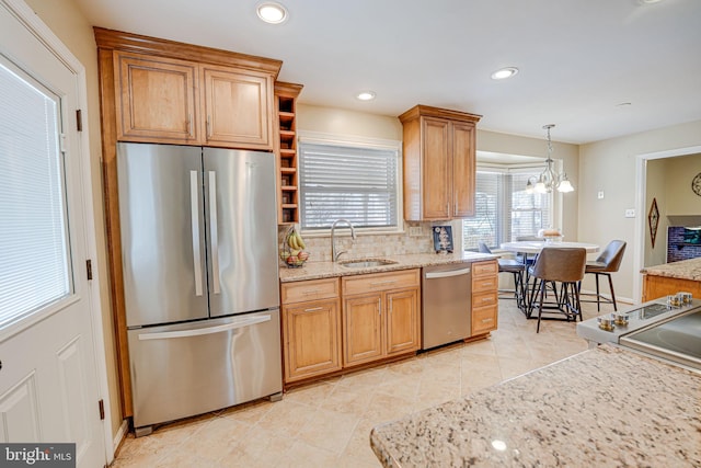 kitchen with pendant lighting, tasteful backsplash, recessed lighting, appliances with stainless steel finishes, and a sink