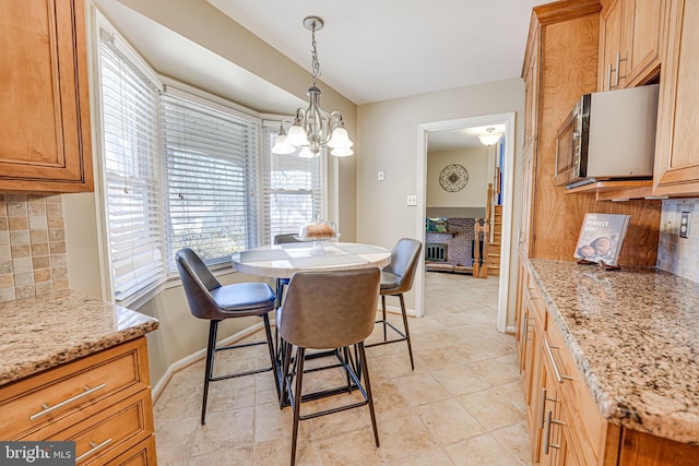 dining area with baseboards and a notable chandelier