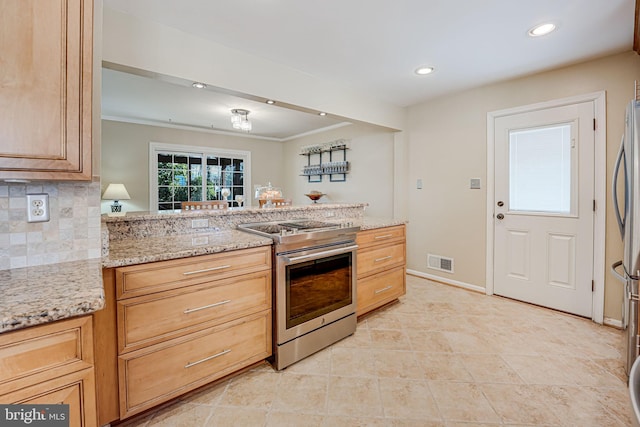 kitchen featuring stainless steel appliances, light stone countertops, visible vents, and tasteful backsplash