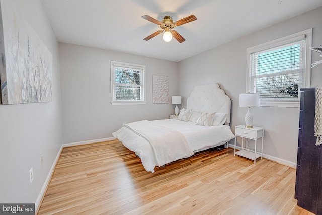 bedroom featuring ceiling fan, wood finished floors, and baseboards