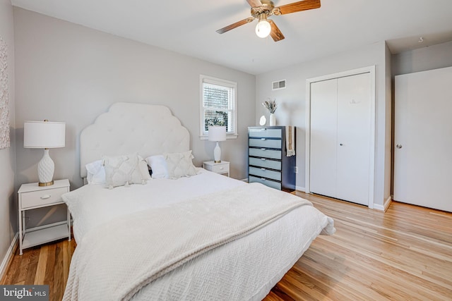 bedroom featuring a closet, visible vents, light wood-style flooring, and baseboards