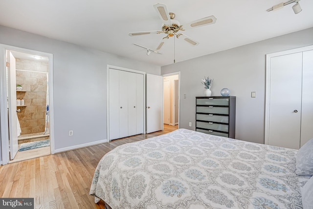 bedroom featuring multiple closets, a ceiling fan, connected bathroom, wood finished floors, and baseboards