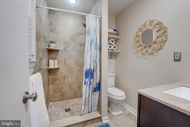 full bath featuring a stall shower, baseboards, vanity, and toilet