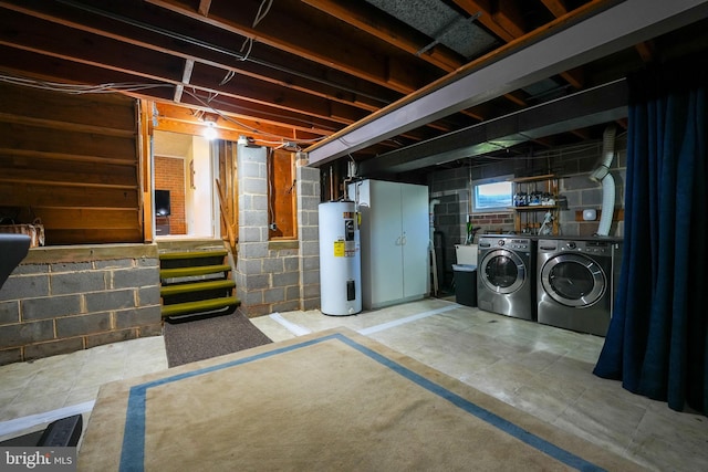 basement with water heater and washer and clothes dryer