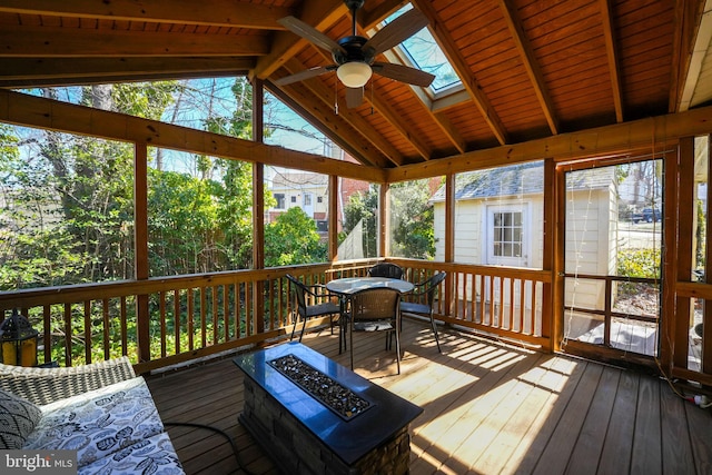 sunroom with vaulted ceiling with skylight and ceiling fan