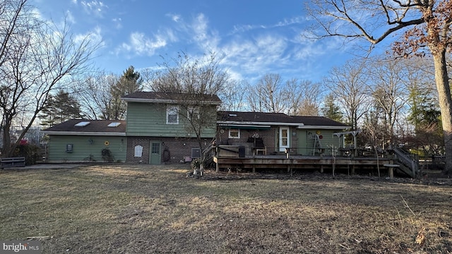 back of house featuring a yard and a deck