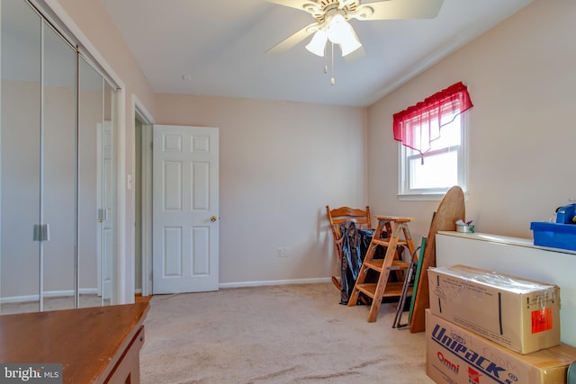 interior space featuring light colored carpet and ceiling fan