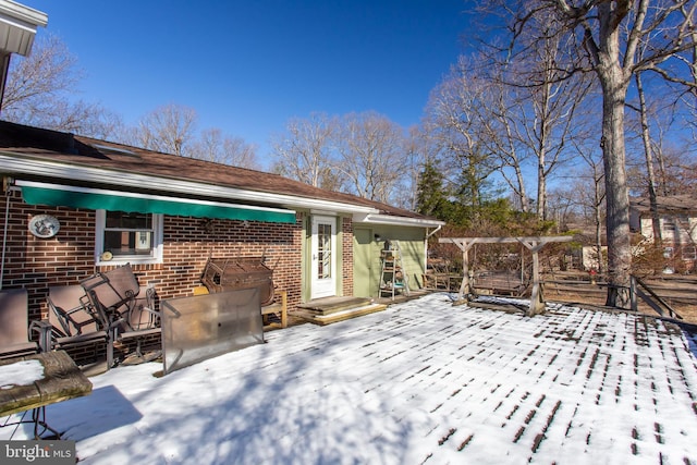 snow covered deck with a patio