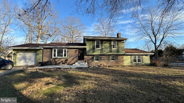 split level home with a garage and a front yard