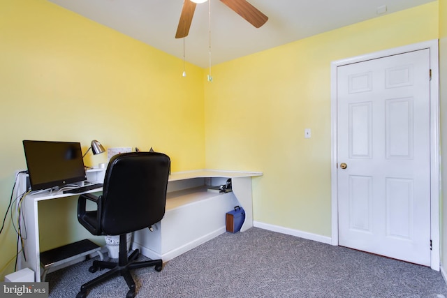 office space with ceiling fan and dark colored carpet