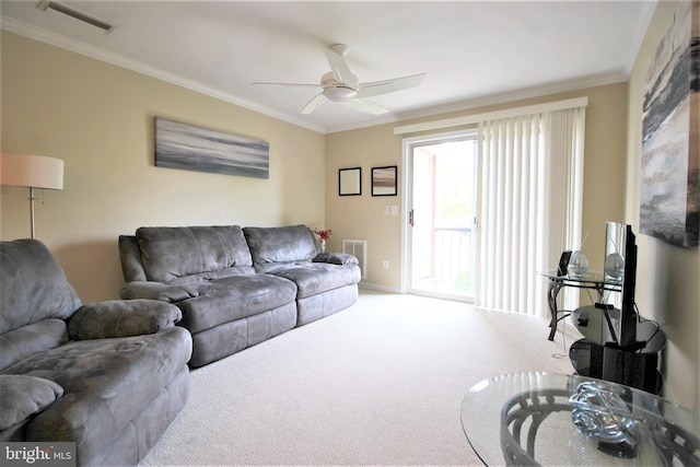 living room with a ceiling fan, carpet, visible vents, and crown molding