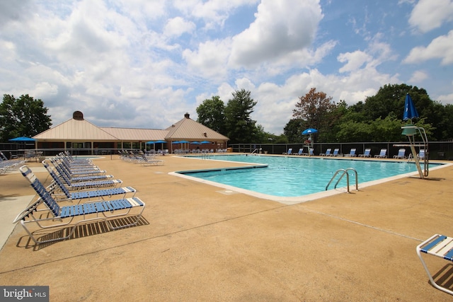 pool featuring a patio area and fence