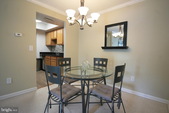 dining room with ornamental molding, an inviting chandelier, and baseboards