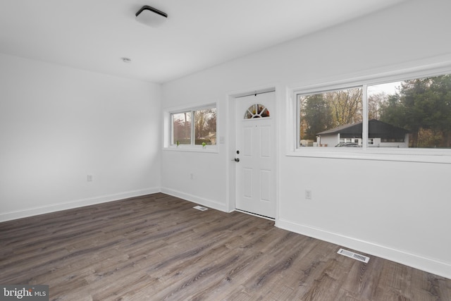 foyer with visible vents, baseboards, and wood finished floors