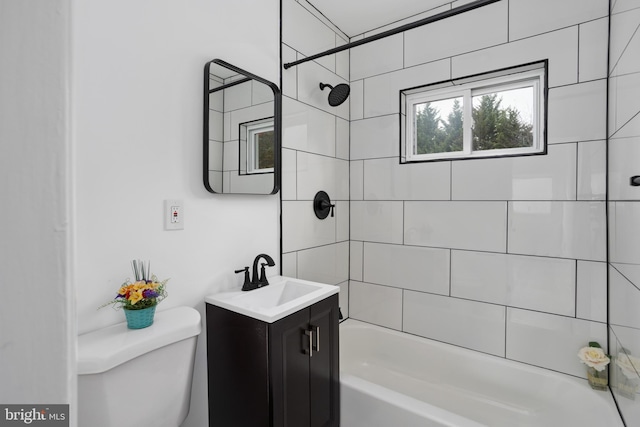 bathroom with toilet, vanity, and shower / bathtub combination