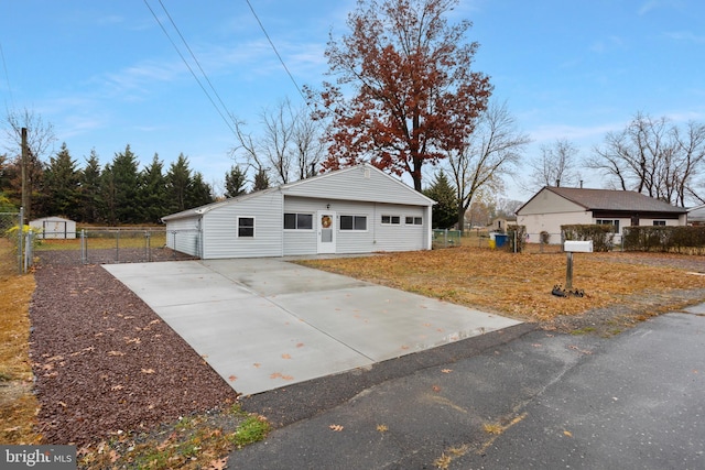 view of front facade featuring an outbuilding, fence, and a gate