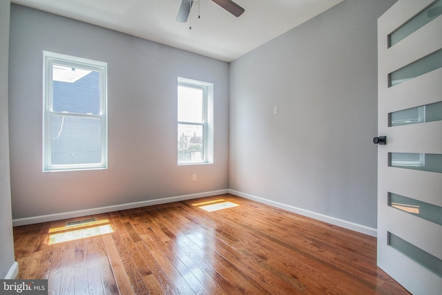 spare room with wood-type flooring and ceiling fan