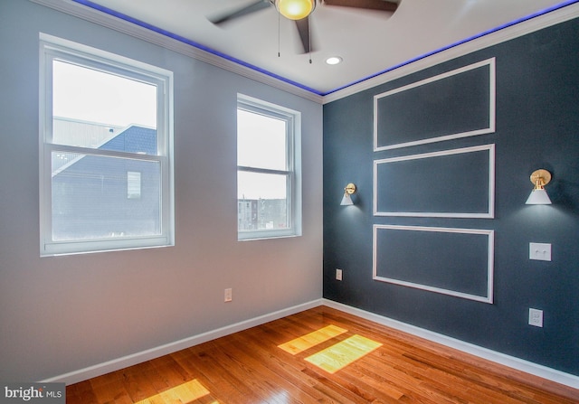 unfurnished room with ceiling fan, ornamental molding, and wood-type flooring