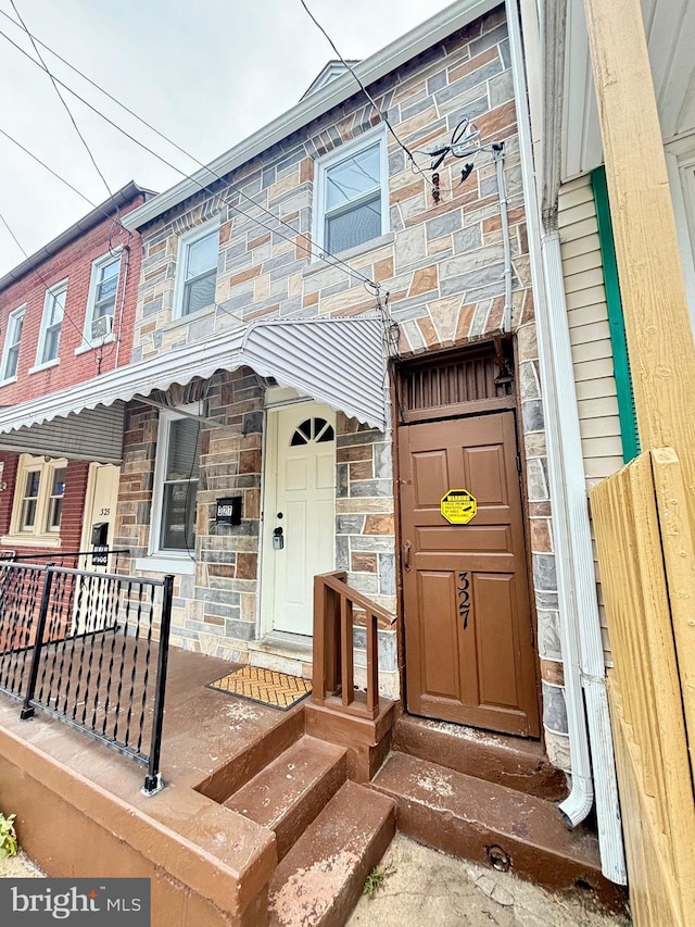 view of property featuring stone siding