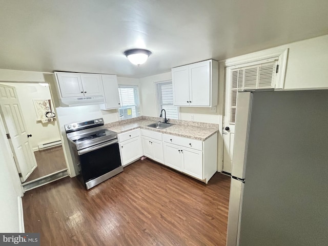 kitchen with under cabinet range hood, a sink, white cabinets, light countertops, and appliances with stainless steel finishes