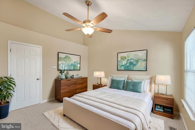 carpeted bedroom featuring lofted ceiling, ceiling fan, and baseboards