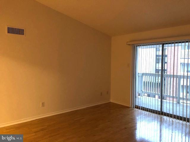 spare room featuring wood-type flooring