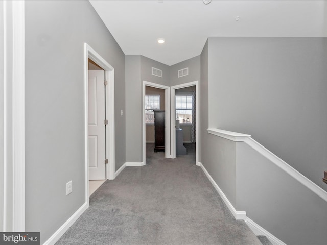 corridor featuring light colored carpet