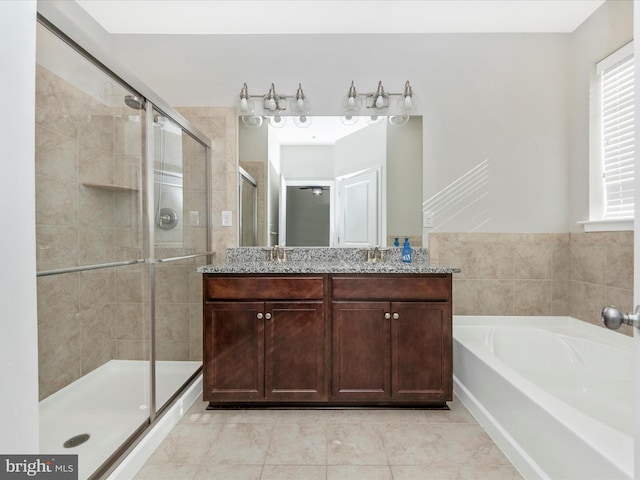 bathroom featuring vanity and shower with separate bathtub