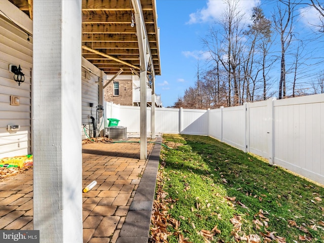 view of yard featuring central AC and a patio