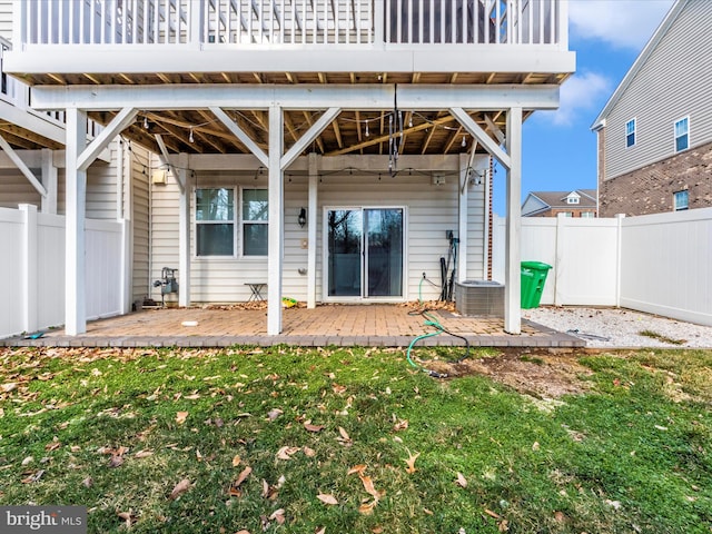 rear view of property featuring a patio and a yard