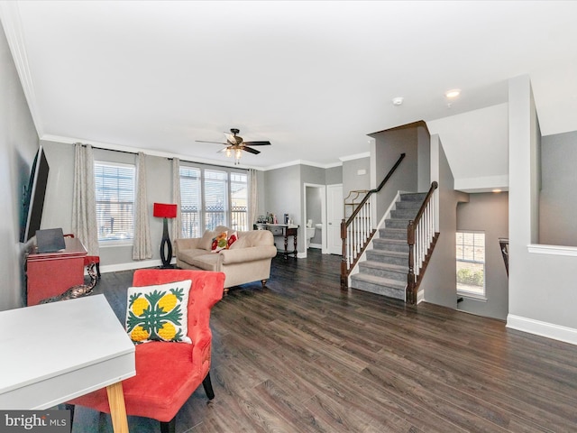 living room featuring dark hardwood / wood-style flooring, ceiling fan, crown molding, and a healthy amount of sunlight