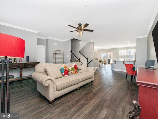 living room featuring crown molding, dark wood-type flooring, and ceiling fan