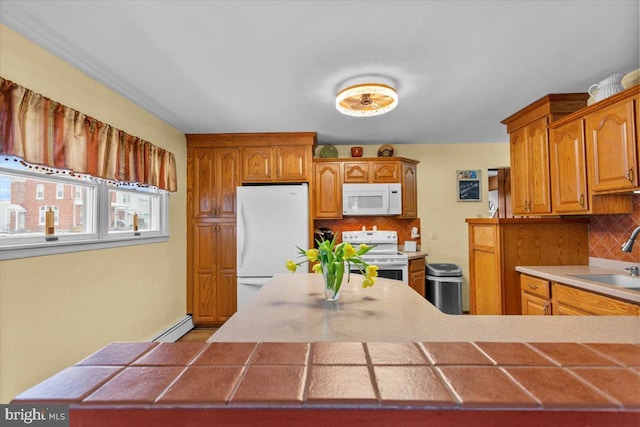 kitchen featuring tasteful backsplash, tile countertops, white appliances, sink, and a baseboard heating unit