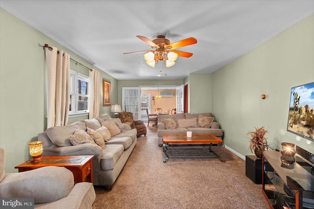 carpeted living room with ceiling fan