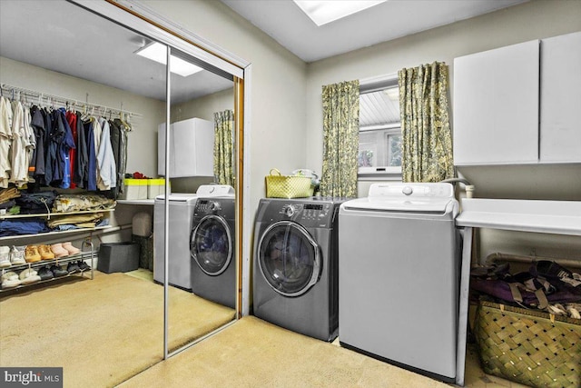 washroom featuring independent washer and dryer and cabinets