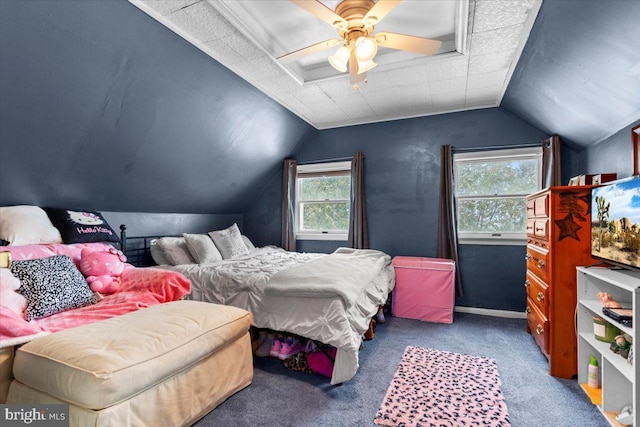 bedroom with ceiling fan, vaulted ceiling, and carpet floors