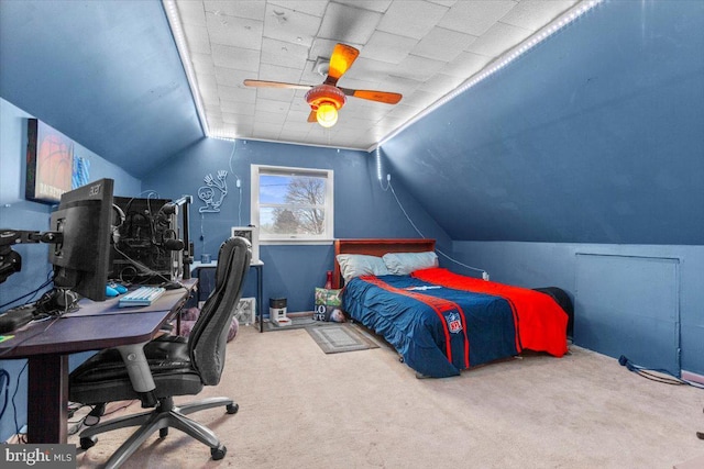 carpeted bedroom with vaulted ceiling and ceiling fan