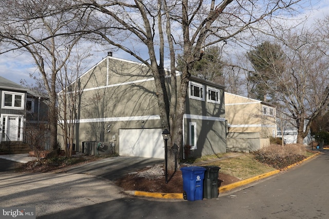 view of side of property with a garage