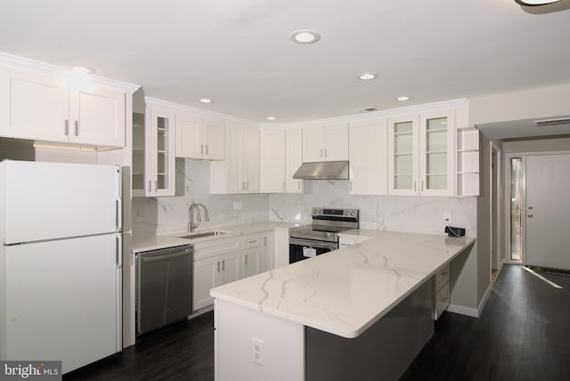 kitchen featuring appliances with stainless steel finishes, white cabinets, light stone counters, and kitchen peninsula