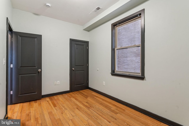 unfurnished bedroom featuring light wood-type flooring