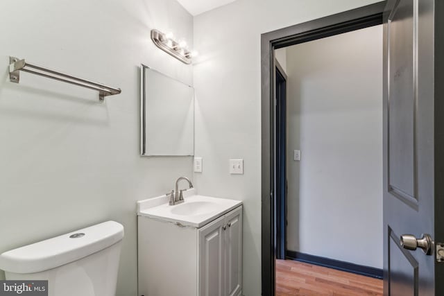 bathroom featuring hardwood / wood-style flooring, vanity, and toilet