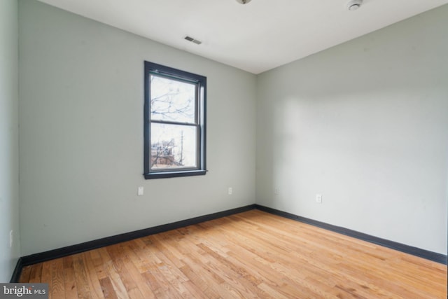 empty room with hardwood / wood-style flooring