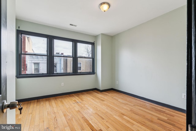 unfurnished room featuring light wood-type flooring