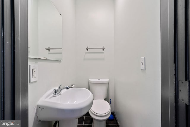 bathroom with tile patterned flooring, sink, and toilet