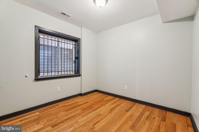 spare room with light wood-type flooring