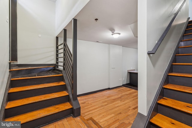 stairs with wood-type flooring