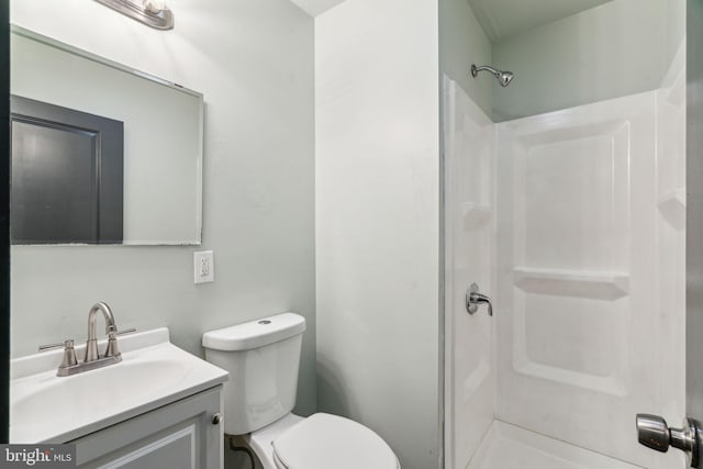 bathroom with vanity, walk in shower, and toilet