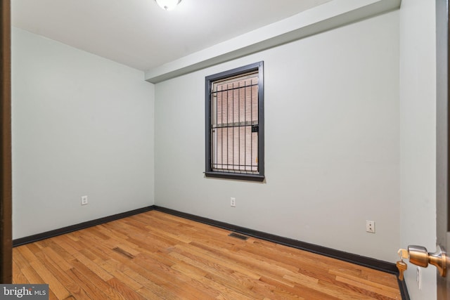 spare room featuring hardwood / wood-style floors