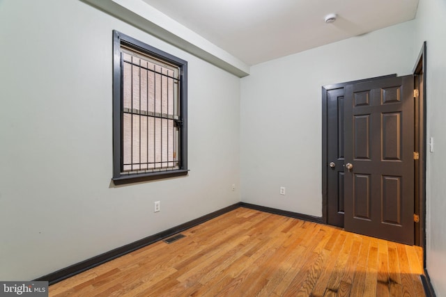 unfurnished room featuring hardwood / wood-style flooring