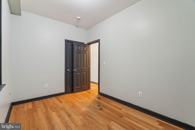 empty room with light hardwood / wood-style flooring